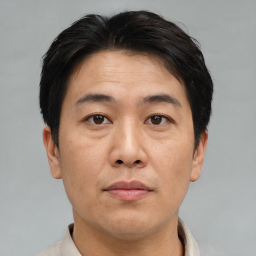 Neutral asian adult male with short  brown hair and brown eyes
