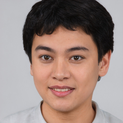 Joyful asian young-adult male with short  brown hair and brown eyes