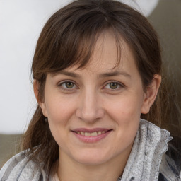 Joyful white adult female with medium  brown hair and grey eyes