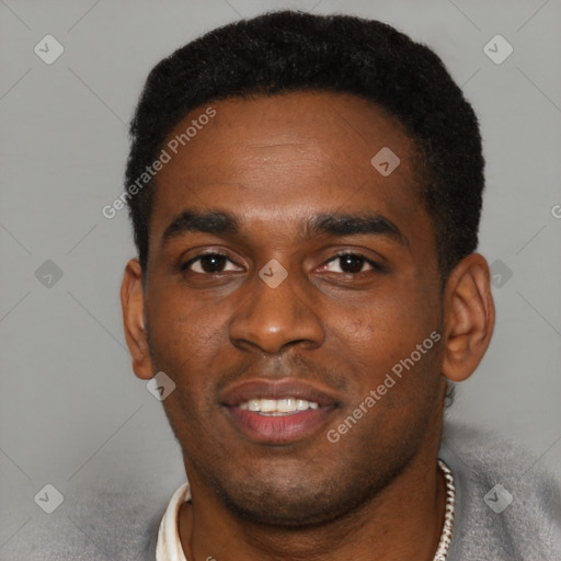 Joyful black young-adult male with short  black hair and brown eyes