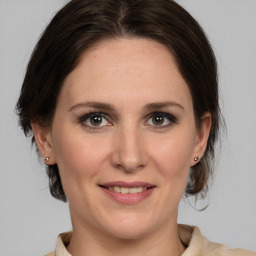 Joyful white adult female with medium  brown hair and grey eyes