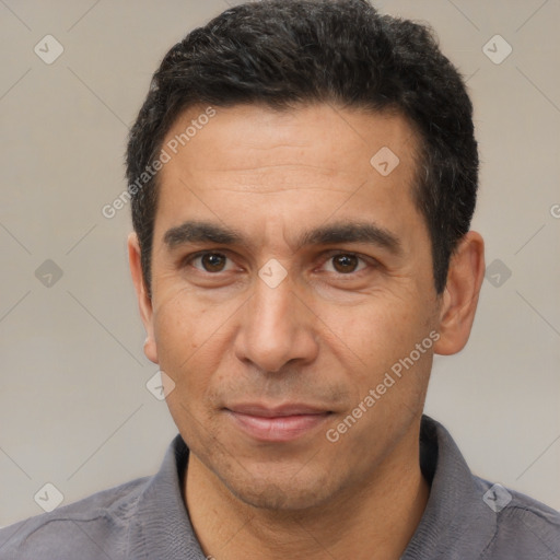 Joyful white adult male with short  black hair and brown eyes