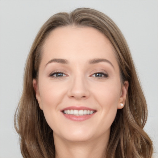 Joyful white young-adult female with long  brown hair and grey eyes