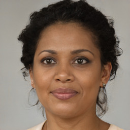 Joyful black adult female with medium  brown hair and brown eyes