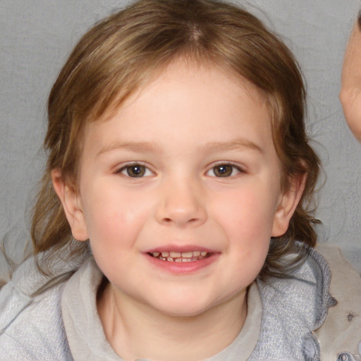 Joyful white child female with medium  brown hair and blue eyes