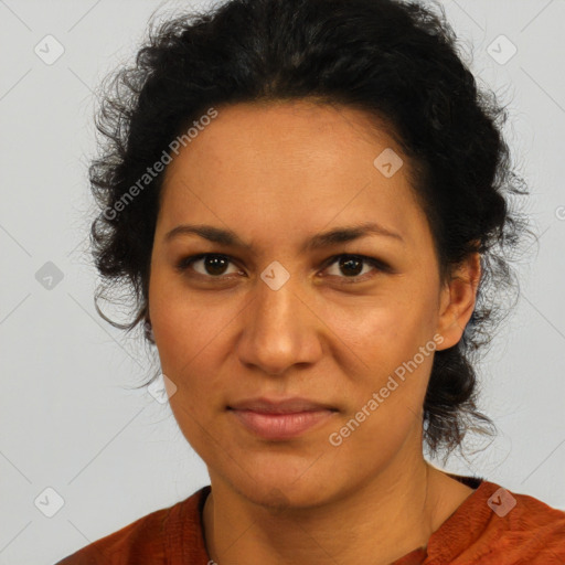 Joyful latino adult female with medium  brown hair and brown eyes