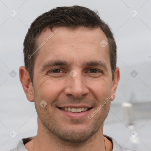 Joyful white adult male with short  brown hair and brown eyes