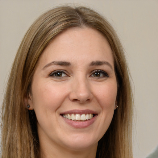 Joyful white young-adult female with long  brown hair and brown eyes