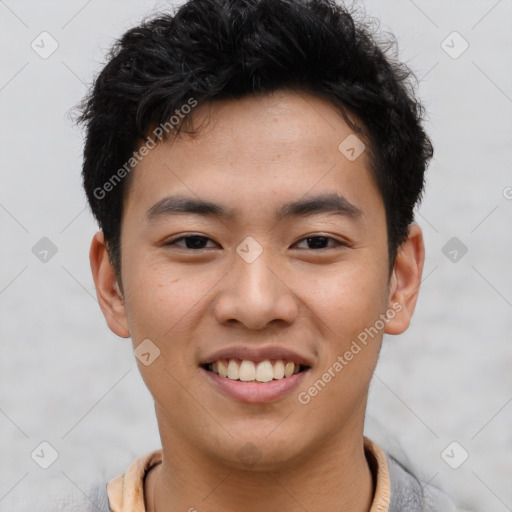 Joyful asian young-adult male with short  black hair and brown eyes