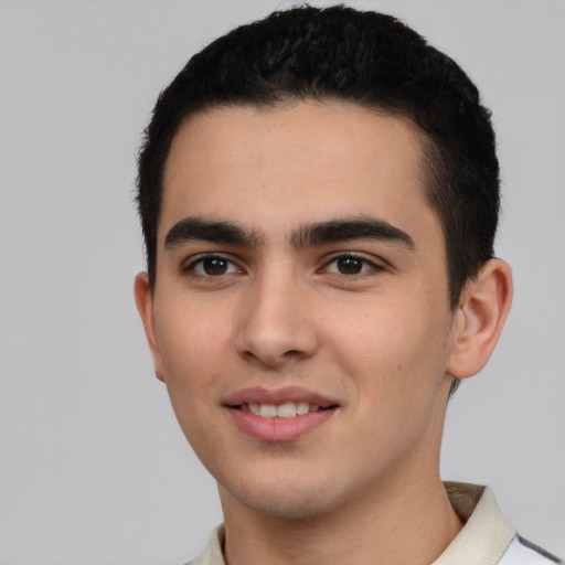 Joyful latino young-adult male with short  black hair and brown eyes