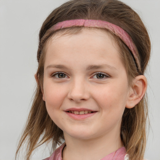 Joyful white child female with medium  brown hair and grey eyes