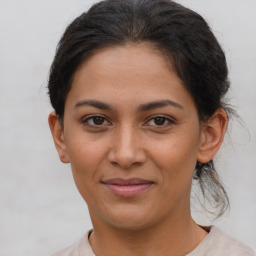 Joyful latino young-adult female with short  brown hair and brown eyes