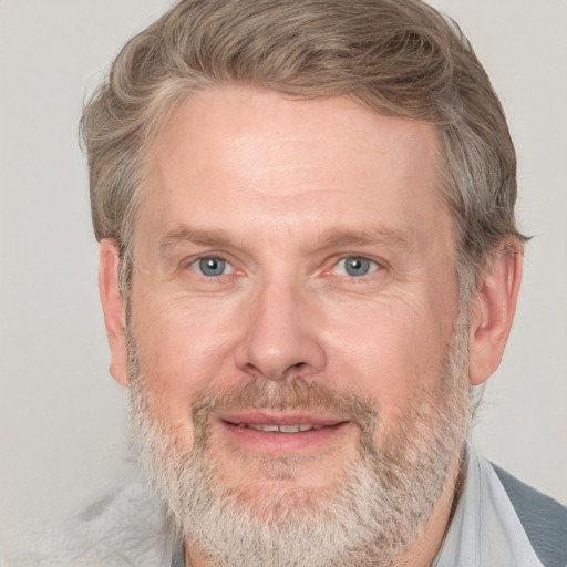 Joyful white adult male with short  brown hair and grey eyes