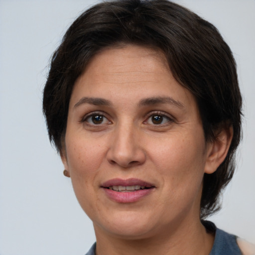 Joyful white adult female with medium  brown hair and brown eyes