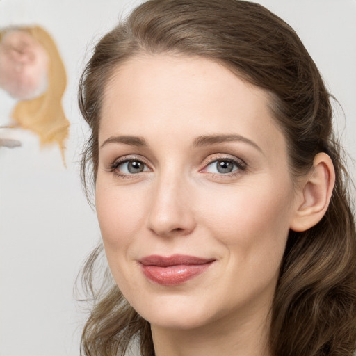 Joyful white young-adult female with long  brown hair and blue eyes