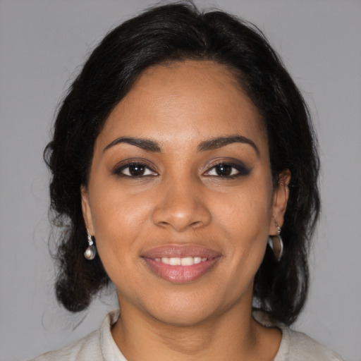 Joyful black young-adult female with medium  brown hair and brown eyes