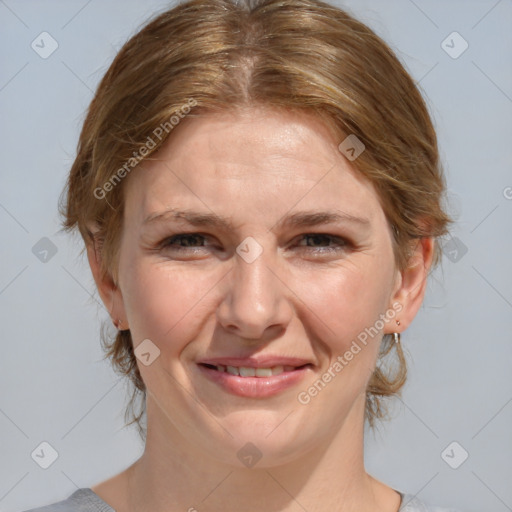 Joyful white adult female with medium  brown hair and blue eyes