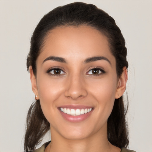 Joyful white young-adult female with medium  brown hair and brown eyes