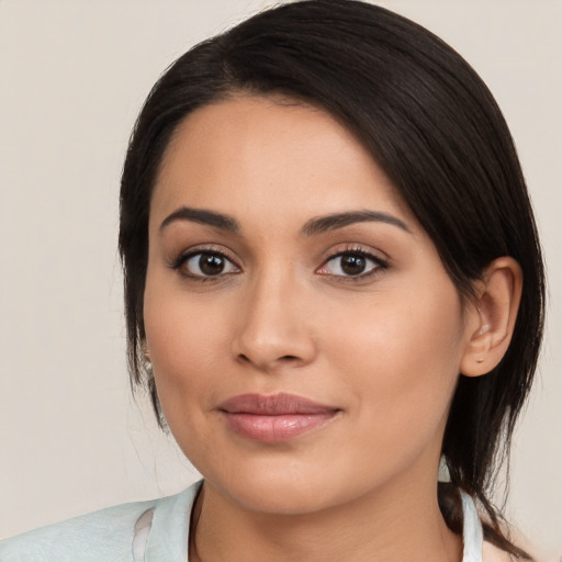 Joyful latino young-adult female with medium  brown hair and brown eyes