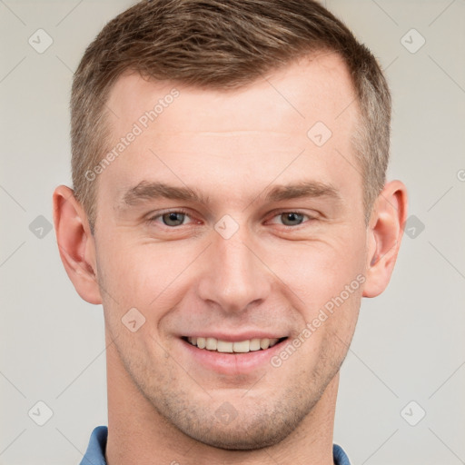 Joyful white young-adult male with short  brown hair and grey eyes