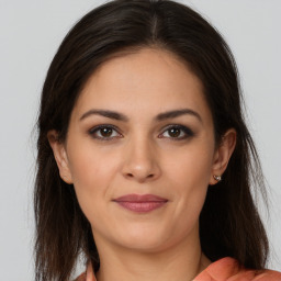 Joyful white young-adult female with long  brown hair and brown eyes