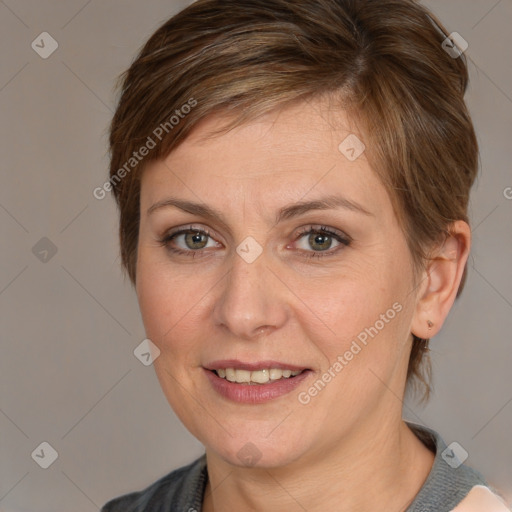 Joyful white adult female with medium  brown hair and grey eyes