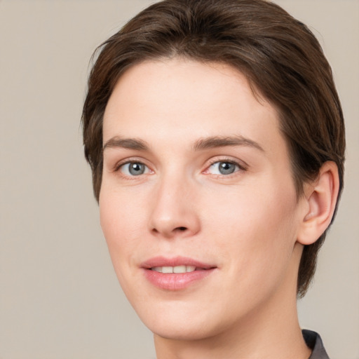 Joyful white young-adult female with medium  brown hair and grey eyes