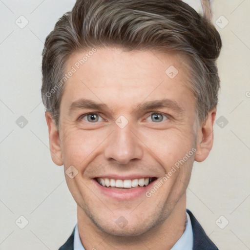 Joyful white adult male with short  brown hair and grey eyes