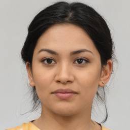 Joyful latino young-adult female with medium  brown hair and brown eyes