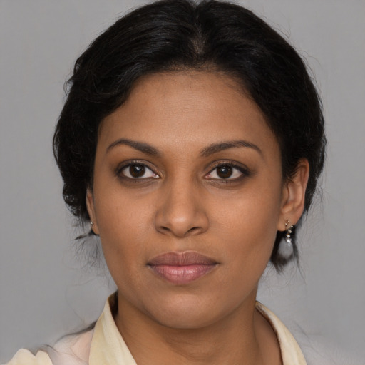 Joyful black young-adult female with medium  brown hair and brown eyes