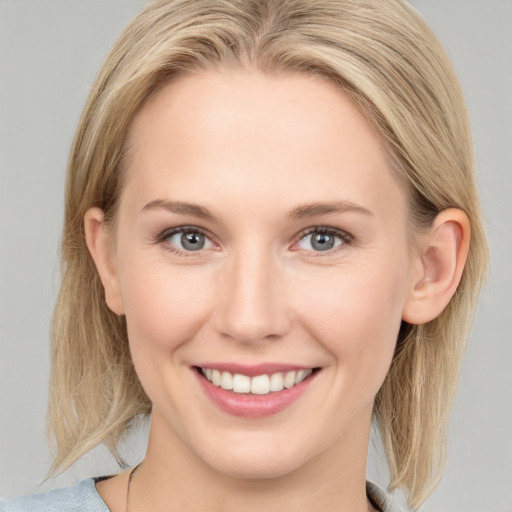 Joyful white young-adult female with medium  brown hair and blue eyes