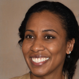 Joyful black adult female with long  brown hair and brown eyes