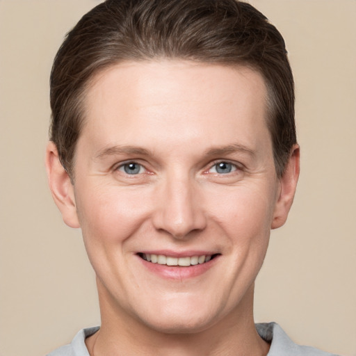 Joyful white adult male with short  brown hair and grey eyes