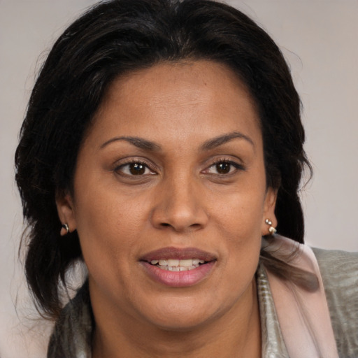 Joyful black adult female with medium  brown hair and brown eyes