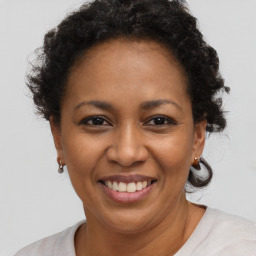 Joyful black adult female with short  brown hair and brown eyes