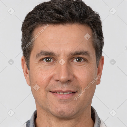 Joyful white adult male with short  brown hair and brown eyes