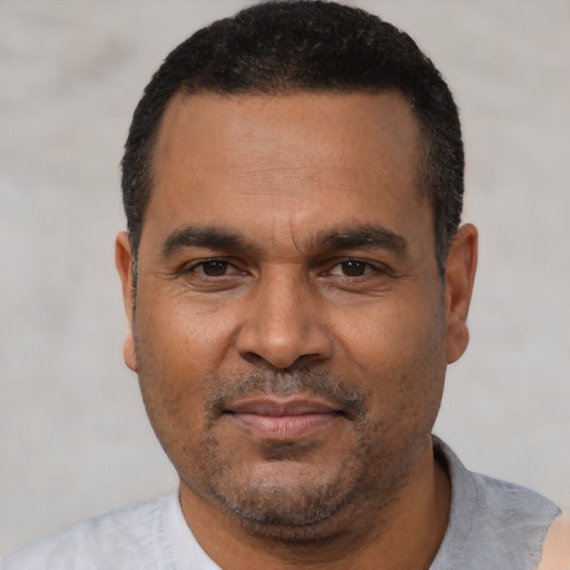 Neutral latino adult male with short  black hair and brown eyes