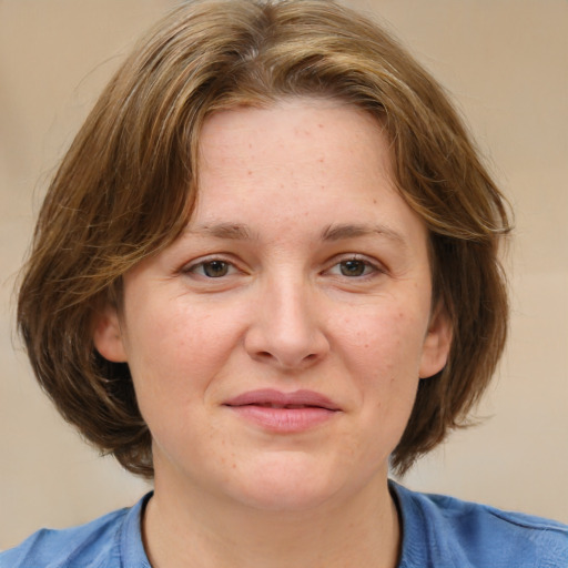 Joyful white young-adult female with medium  brown hair and blue eyes