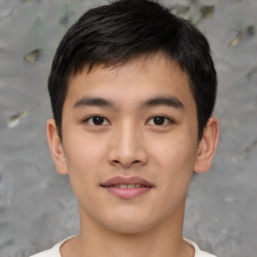 Joyful asian young-adult male with short  brown hair and brown eyes