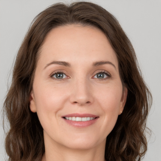 Joyful white young-adult female with medium  brown hair and green eyes