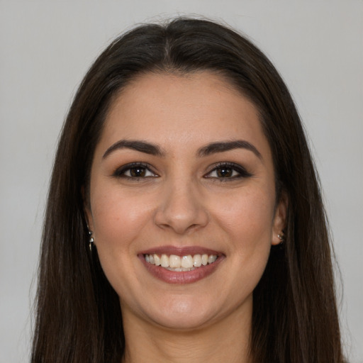 Joyful white young-adult female with long  brown hair and brown eyes