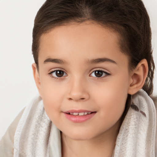 Joyful white child female with long  brown hair and brown eyes