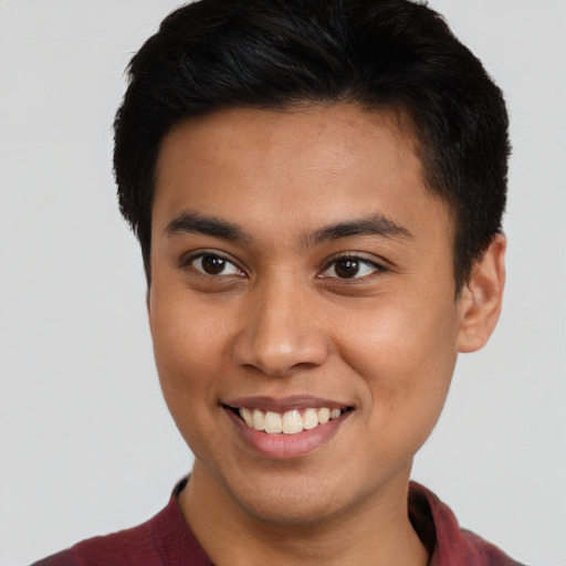 Joyful latino young-adult male with short  brown hair and brown eyes