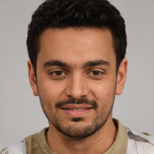 Joyful white young-adult male with short  black hair and brown eyes