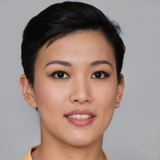 Joyful asian young-adult female with short  black hair and brown eyes