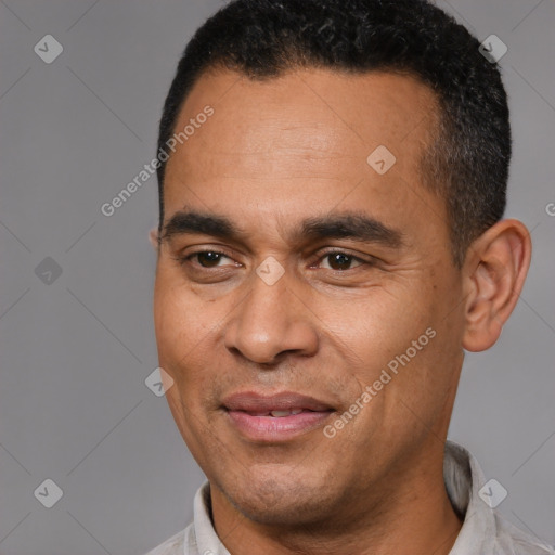 Joyful latino adult male with short  black hair and brown eyes