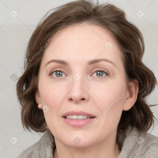 Joyful white adult female with medium  brown hair and blue eyes