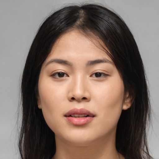 Joyful asian young-adult female with long  brown hair and brown eyes
