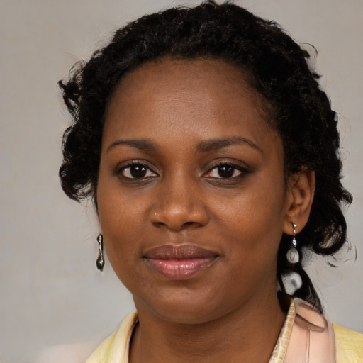 Joyful black young-adult female with medium  brown hair and brown eyes