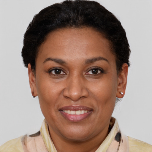 Joyful latino adult female with short  brown hair and brown eyes